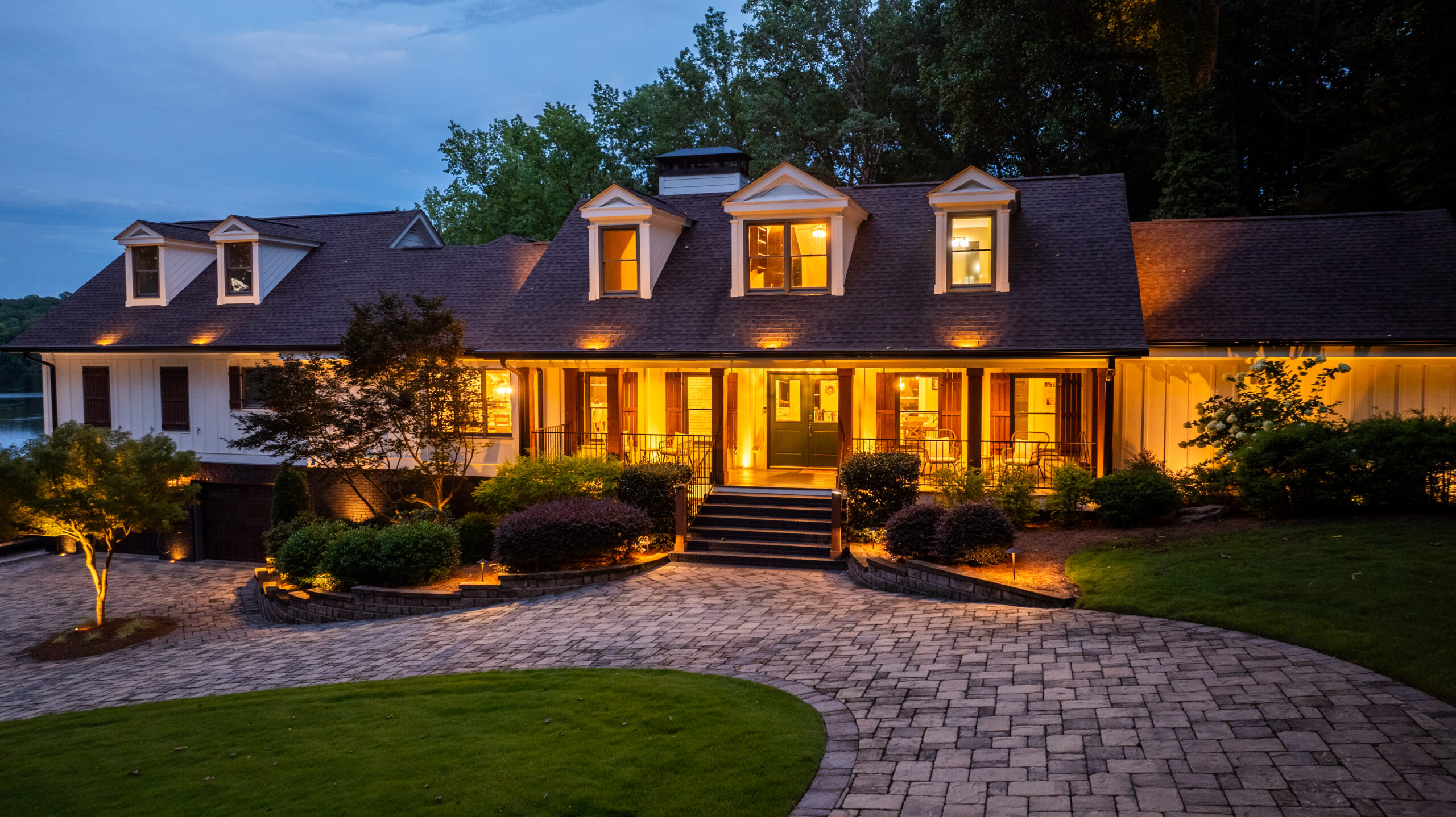Elegant landscape lighting and hardscape driveway by A Abby Group in Metro Atlanta.