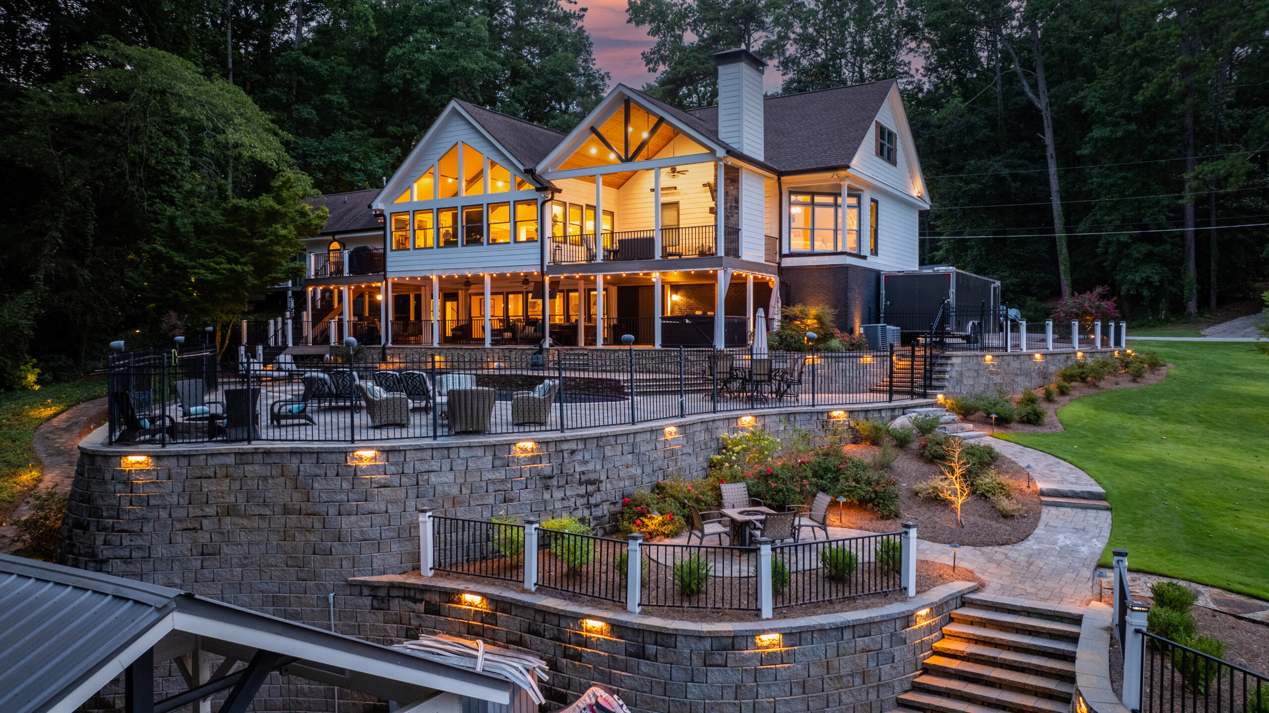 Multi-tiered landscape lighting and retaining walls by A Abby Group in Metro Atlanta.