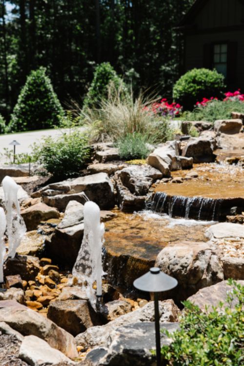 Backyard rock fountain with small waterfall and plants in Metro Atlanta