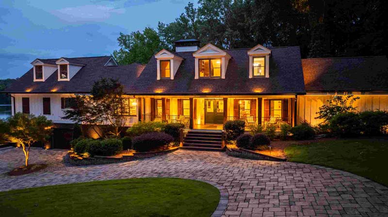Elegant landscape lighting and hardscape driveway by A Abby Group in Metro Atlanta.