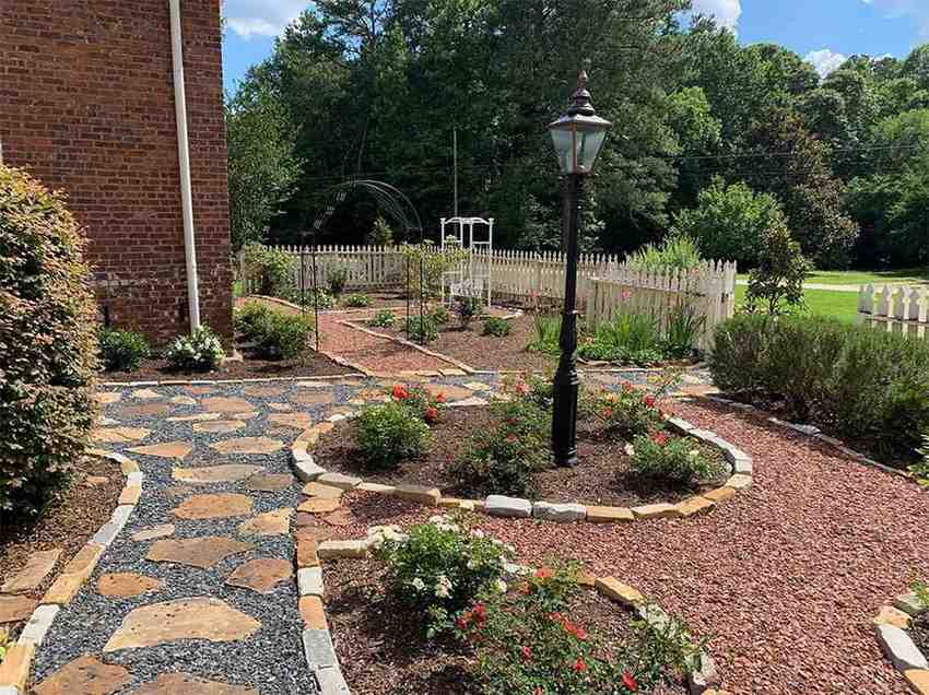 Stone and gravel garden paths with flower beds and lamp post in Metro Atlanta