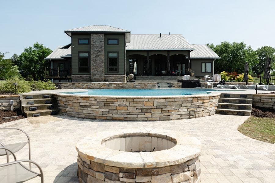 Modern backyard with pool, fire pit, and stone patio in Metro Atlanta