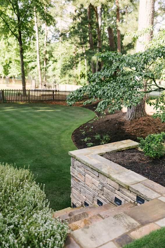Stone retaining wall beside a green landscaped yard in Metro Atlanta