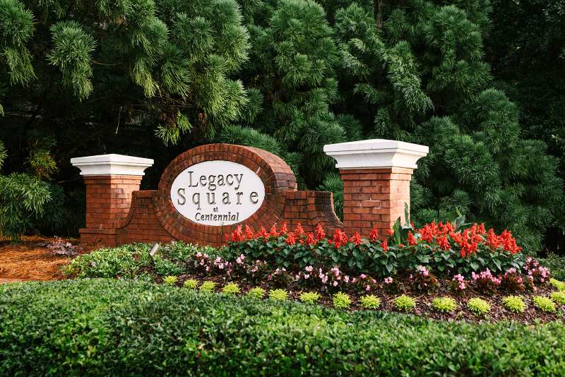 Flower bed with seasonal blooms at Legacy Square sign in Metro Atlanta